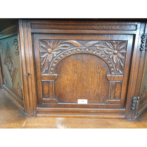 34 - A reproduction oak Court Cupboard with central cupboard flanked by turned columns, above pair of fit... 