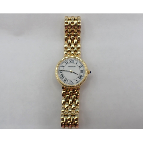 103 - A lady's Tourneau quartz Wristwatch the white enamel dial with black roman numerals in 14ct gold cas... 