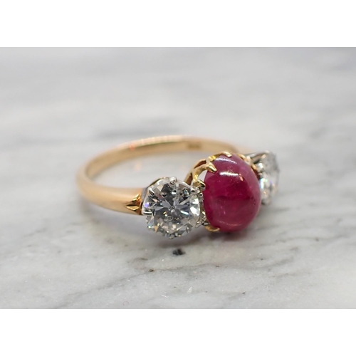 121 - A Ruby and Diamond three stone Ring claw-set oval ruby cabochon between two brilliant-cut diamonds, ... 