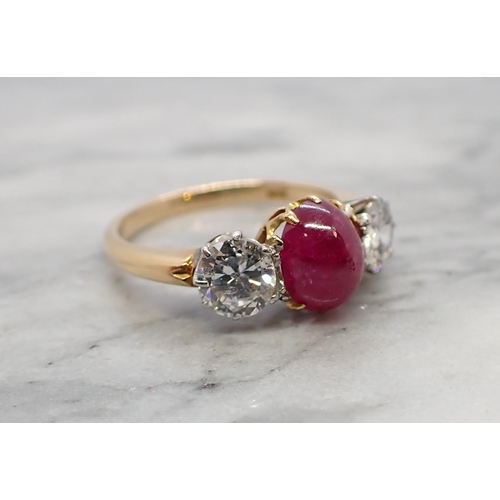 121 - A Ruby and Diamond three stone Ring claw-set oval ruby cabochon between two brilliant-cut diamonds, ... 