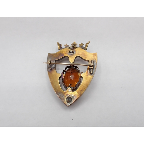 123 - A Scottish Shield Brooch claw-set Madeira citrine and hard stones in yellow metal, 5.5cms long, appr... 