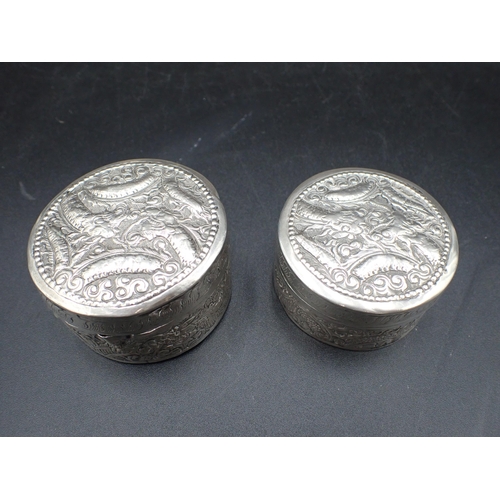 13 - Two Cambodian silver circular Boxes embossed dragons, etc, approx, 2½in