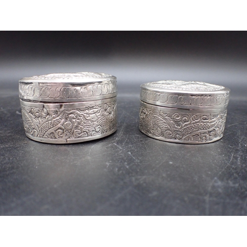 13 - Two Cambodian silver circular Boxes embossed dragons, etc, approx, 2½in