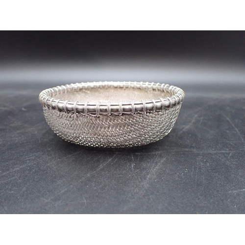 14 - An Eastern woven silver Basket with simulated bamboo rim, 4¾in