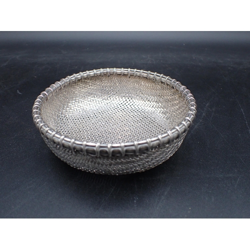 14 - An Eastern woven silver Basket with simulated bamboo rim, 4¾in