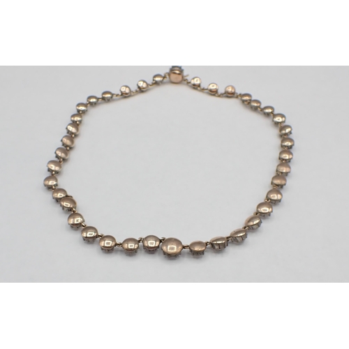 147 - A Georgian Riviere Necklace close-set graduated round paste in silver backed with gold, 35.5cms long