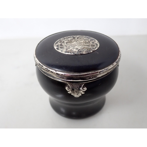 15 - An 18th Century white metal mounted ebonised Snuff Mull of bombe form, the hinged lid with inset pan... 