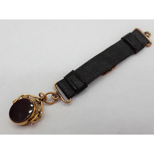 155 - A 15ct gold Swivel Fob set bloodstone and carnelian on leather strap