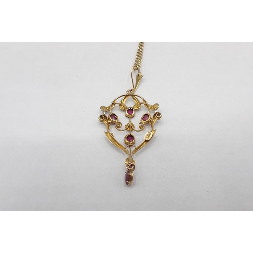 162 - An early 20th Century Garnet and Seed Pearl Pendant the openwork plaque claw-set five oval-cut garne... 