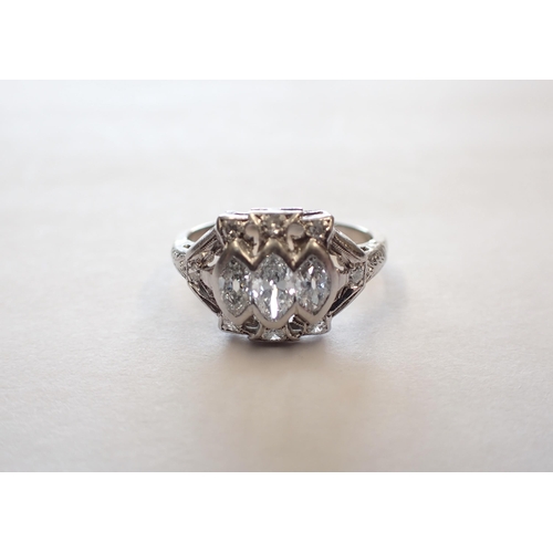 163 - A mid 20th Century Diamond three stone Ring the pierced mount rubover-set graduated marquise-cut sto... 