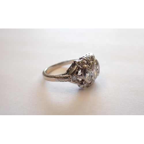 163 - A mid 20th Century Diamond three stone Ring the pierced mount rubover-set graduated marquise-cut sto... 