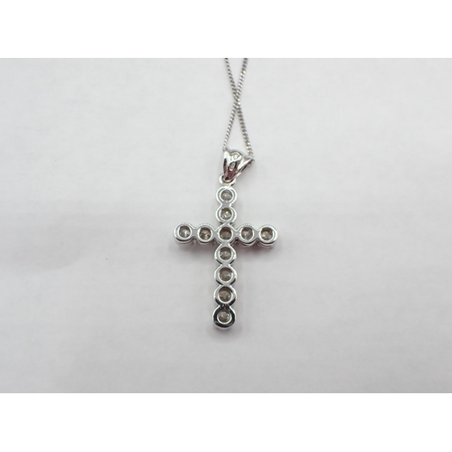 173 - A contemporary Diamond Cross, claw-set eleven brilliant-cut stones, estimated total diamond weight 1... 