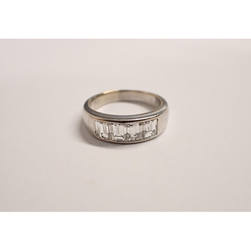 177 - A Diamond four stone Ring channel-set graduated step-cut stones, estimated total diamond weight, 0.9... 