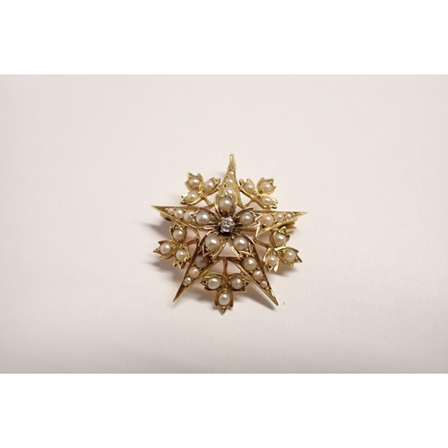 180 - A Diamond and Seed Pearl Star Pendant/Brooch claw-set old-cut diamond within seed pearls, marked 15c... 