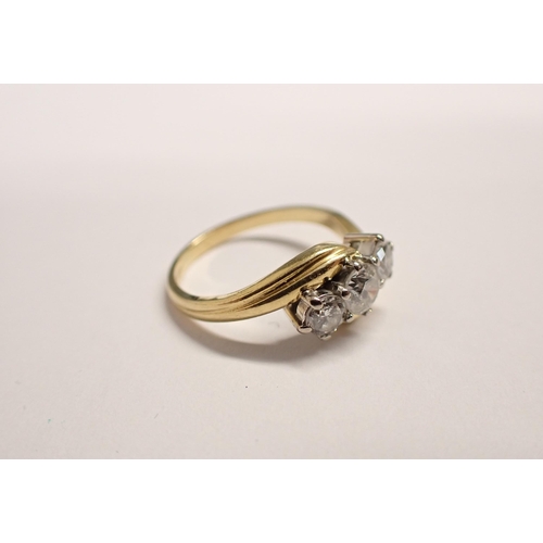 190 - A Diamond three stone crossover Ring claw-set graduated brilliant-cut stones, estimated total diamon... 