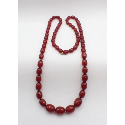 193 - A string of graduated Cherry Amber type Beads, approx 65cms long,  approx 32gms