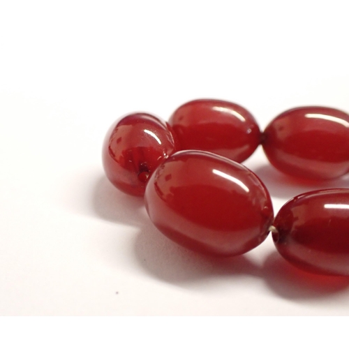 193 - A string of graduated Cherry Amber type Beads, approx 65cms long,  approx 32gms