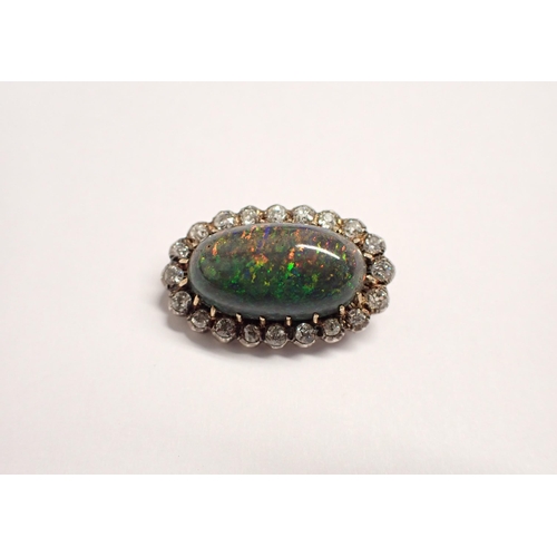 199 - An Opal and Diamond Brooch claw-set oval cabochon within a frame of old-cut diamonds in silver backe... 