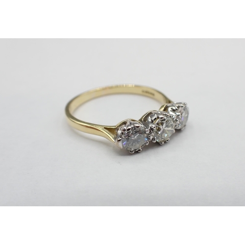 201 - A Diamond three stone Ring claw-set graduated brilliant-cut stones, estimated total diamond weight 1... 