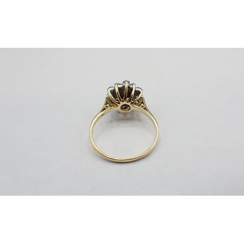 202 - A Diamond flower cluster Ring claw-set nineteen eight-cut stones in 18ct gold, ring size Q 1/2