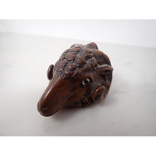 23 - A carved treen Snuff Mull in the form of a ram's head with inset glass eyes, 3in