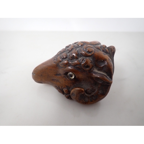 23 - A carved treen Snuff Mull in the form of a ram's head with inset glass eyes, 3in