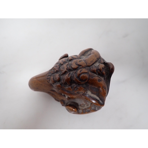 23 - A carved treen Snuff Mull in the form of a ram's head with inset glass eyes, 3in