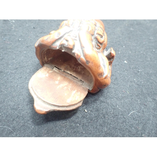 23 - A carved treen Snuff Mull in the form of a ram's head with inset glass eyes, 3in