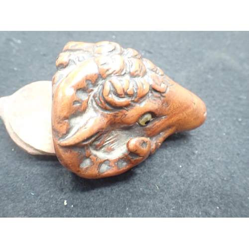 23 - A carved treen Snuff Mull in the form of a ram's head with inset glass eyes, 3in