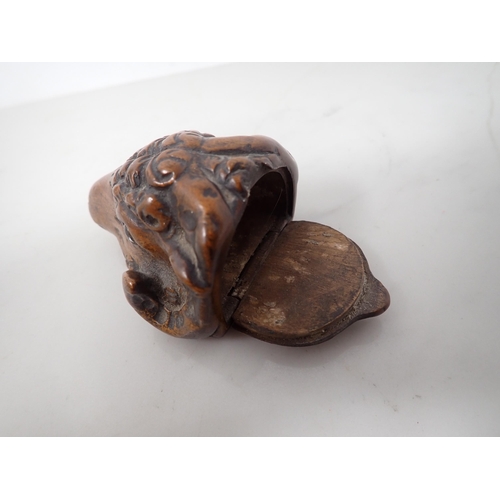 23 - A carved treen Snuff Mull in the form of a ram's head with inset glass eyes, 3in