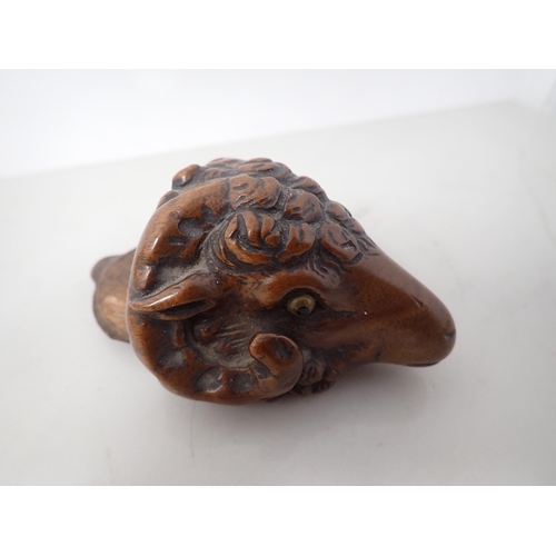 23 - A carved treen Snuff Mull in the form of a ram's head with inset glass eyes, 3in