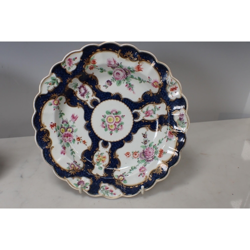 299 - Two Worcester scale blue Plates with shaped rims, floral painted ponds, richly gilt borders, and a C... 