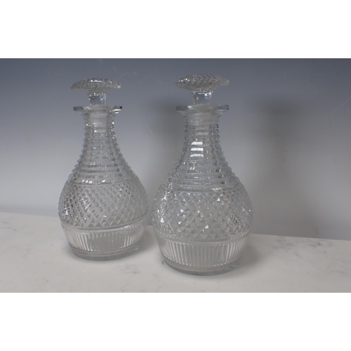 311 - A pair of Georgian cut glass Decanters and Stoppers with diamond cut designs, 9½in H