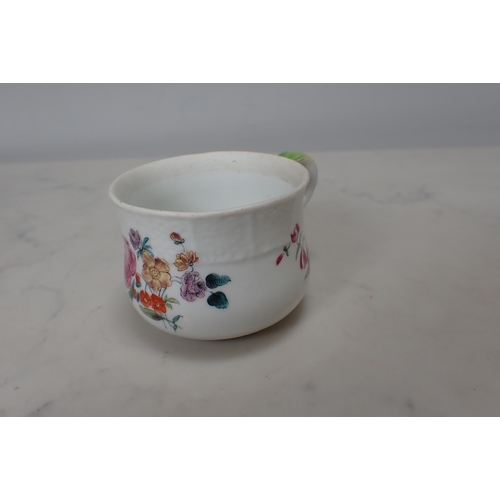 314 - A Meissen polychrome Custard Cup with floral designs and moulded border, scroll handle with green an... 