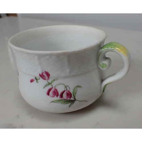 314 - A Meissen polychrome Custard Cup with floral designs and moulded border, scroll handle with green an... 