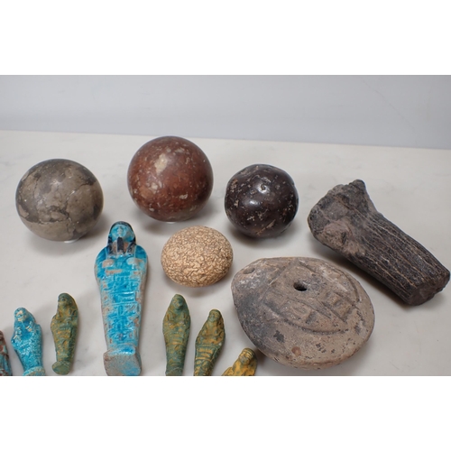 317 - Three spherical stone balls, an Egyptian Mummy Figure, etc