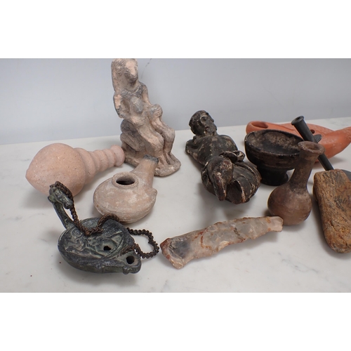 318 - A small collection of Egyptian and other artefacts with oil lamps, carved figures, vase, etc