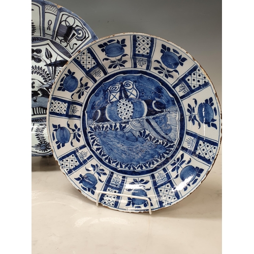 323 - Three 18th Century Delft blue and white Chargers, painted birds, fruit and trellis designs, 12in dia... 