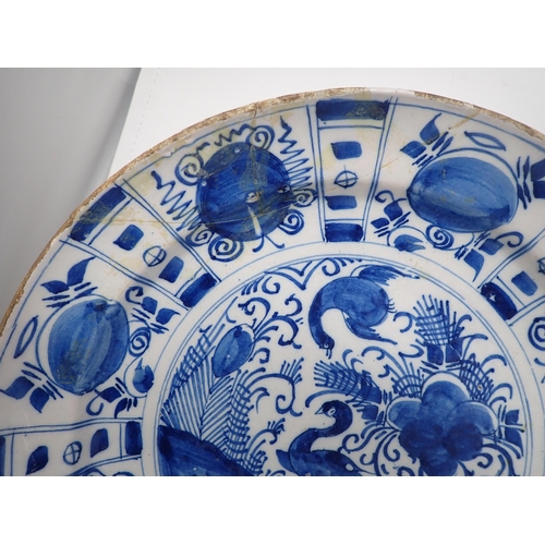 323 - Three 18th Century Delft blue and white Chargers, painted birds, fruit and trellis designs, 12in dia... 