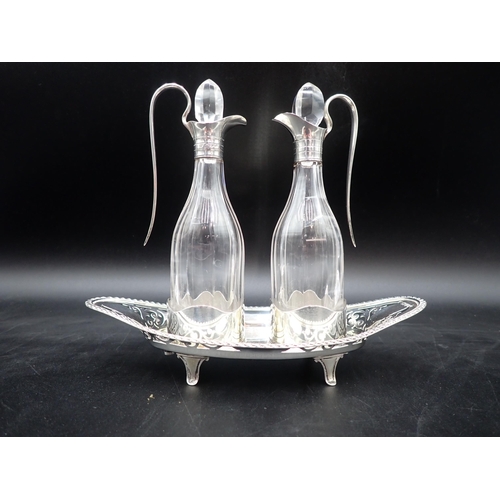 35 - A pair of Edward VII silver-mounted cut-glass Vinegar Bottles on pierced oval stand having gadroon r... 