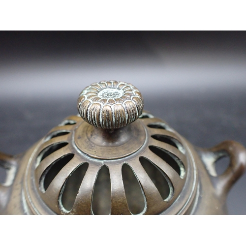 350 - A small bronze Pot Pourri and Cover with flower finial and silver wirework floral inlay, 4in