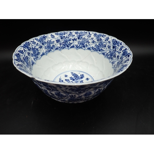 353 - A Chinese blue and white circular Bowl, painted arched panels of flowers, 9in, and another with moul... 