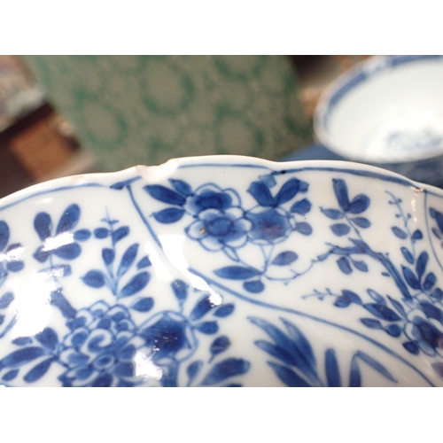 353 - A Chinese blue and white circular Bowl, painted arched panels of flowers, 9in, and another with moul... 