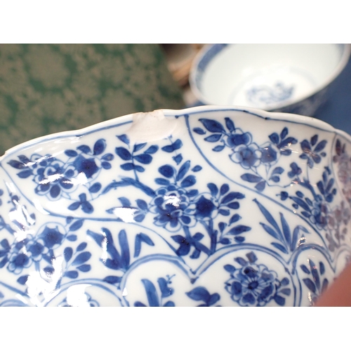 353 - A Chinese blue and white circular Bowl, painted arched panels of flowers, 9in, and another with moul... 