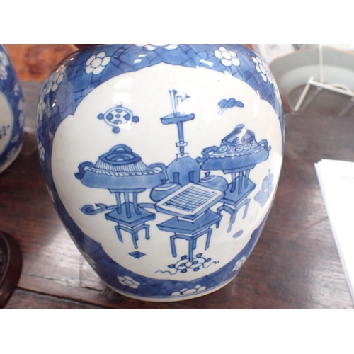 354 - A near pair of Chinese blue and white Ginger Jars with shaped oval reserves painted utensils, etc, p... 