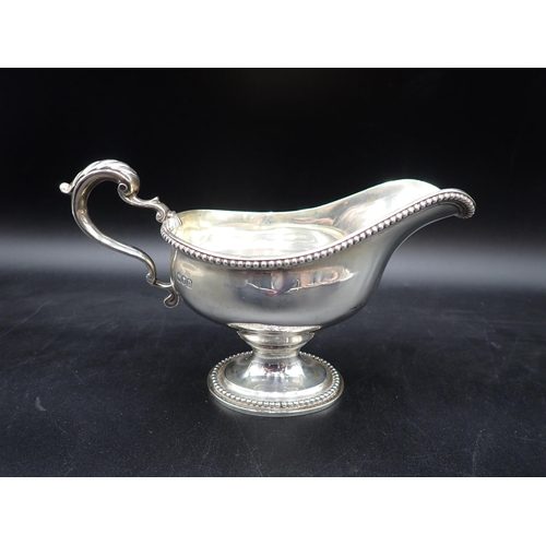 36 - A George V silver Sauce Boat with beaded rims, leafage scroll handle on pedestal base, London 1915, ... 