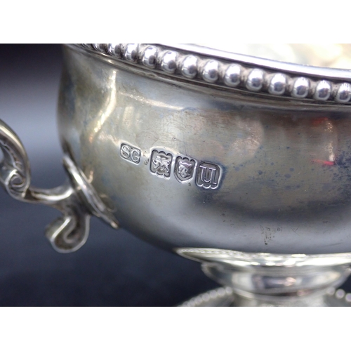 36 - A George V silver Sauce Boat with beaded rims, leafage scroll handle on pedestal base, London 1915, ... 