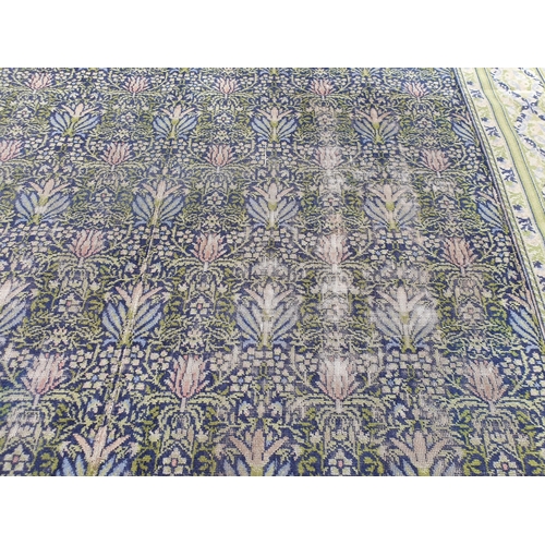 380 - A William Morris design Carpet having floral centre design. multi bordered with diamond shaped desig... 