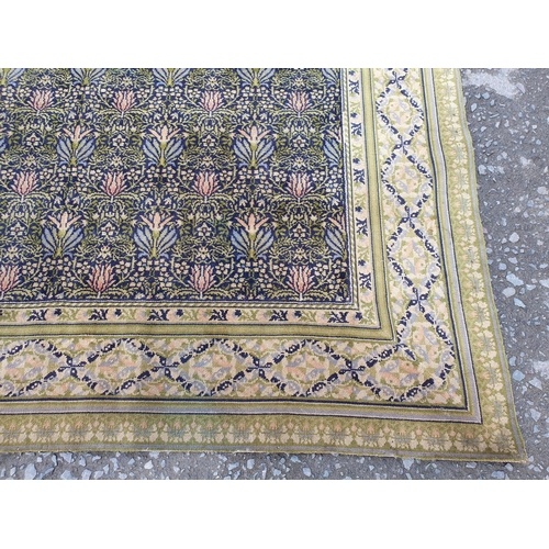 380 - A William Morris design Carpet having floral centre design. multi bordered with diamond shaped desig... 