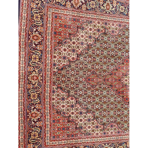 381 - A Persian woollen Rug with graduated lozenges infilled with stylised floral decoration on red, blue ... 